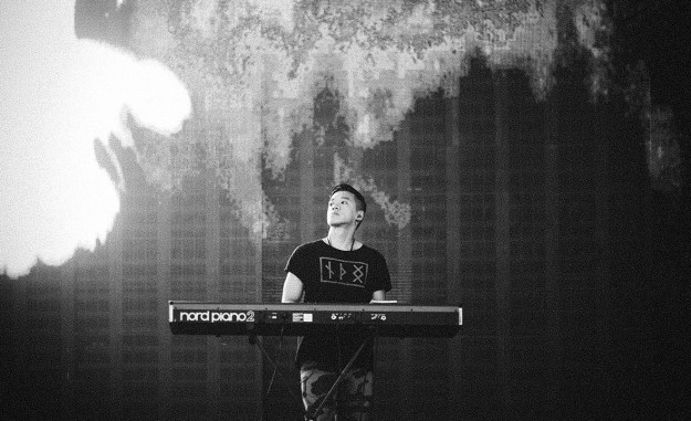 The Theorist at the piano on stage, black and white